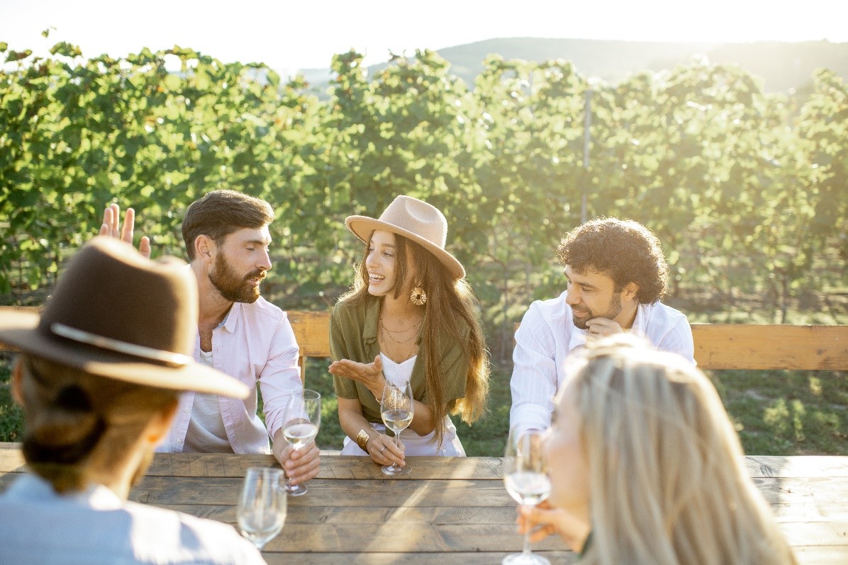 A group of friends sitting at a table on a patio